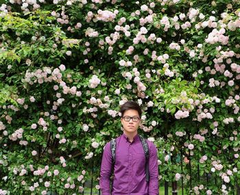 Portrait of man standing on purple flowers