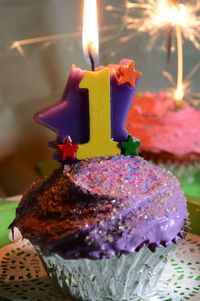 Close-up of illuminated cake on table