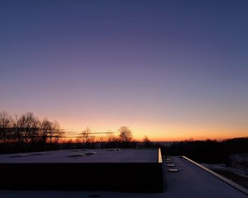 Silhouette trees against sky during winter
