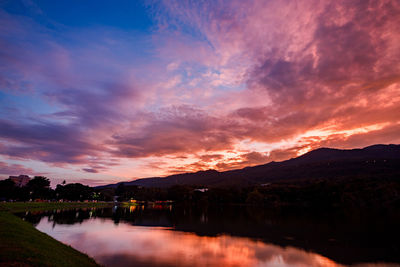 Scenic view of lake against romantic sky at sunset