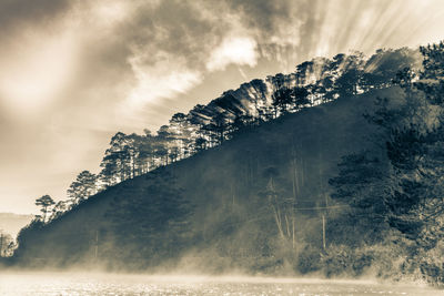 Scenic view of waterfall against sky