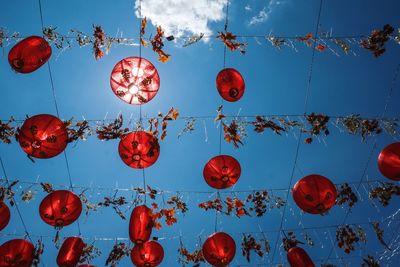 Low angle view of lanterns hanging against sky