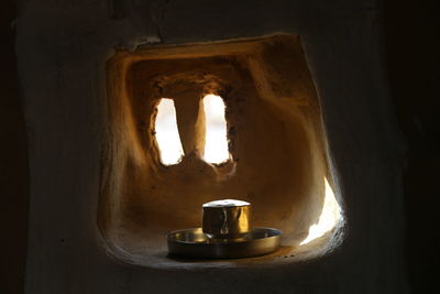 Close-up of lit candles on window