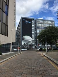 Modern office building against sky in city