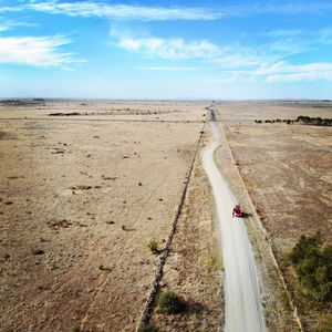 Aerial view of road by landscape against sky