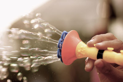 Close-up of hand holding plastic bubble wand