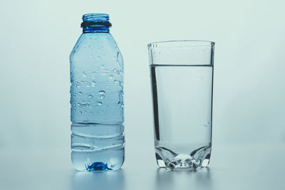 Close-up of glass bottle against blue background