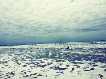 Scenic view of sea against cloudy sky