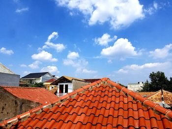 High section of houses against blue sky