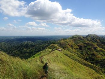 Scenic view of landscape against cloudy sky