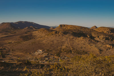 Scenic view of mountains against clear blue sky