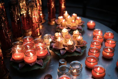 Close-up of illuminated candles on table