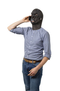 Portrait of young man wearing mask against white background