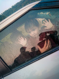 Reflection of man on car window