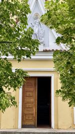 Low angle view of building against trees