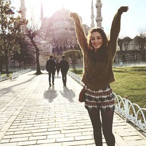 Full length of woman standing on footpath
