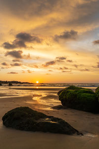 Scenic view of beach against sky during sunset