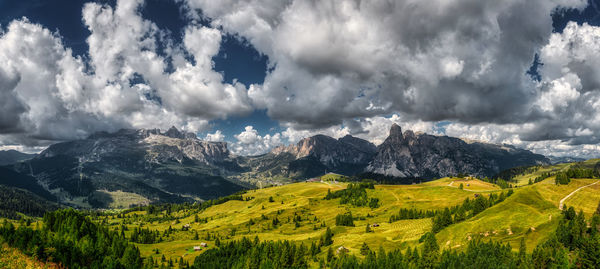 Landscape of alta badia valley seen from the highland pralongià with clouds in the sky