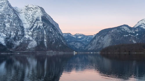 Beautiful alpine lake reflecting surrounding peaks during sunrise, narrow shot, austria, europe