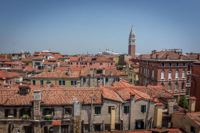 Buildings in town against clear sky