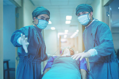 Doctor getting their patient ready for the next procedure in the corridor, a medical team.