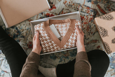 Cropped hand of woman holding gift box