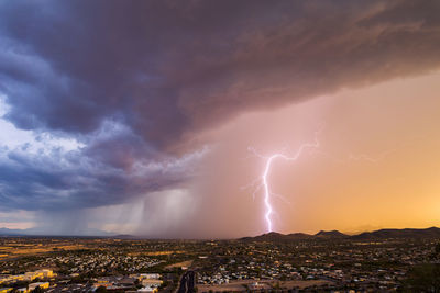 Aerial view of forked lighting over mountain against dramatic sky