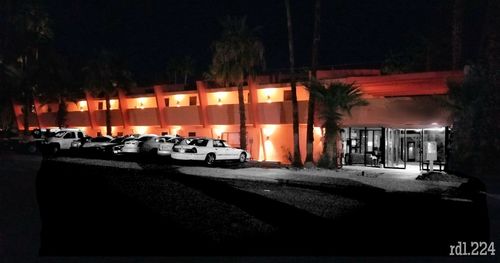 Cars on road by buildings in city at night