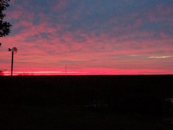 Silhouette landscape against sky during sunset