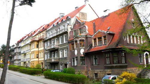 Houses by road against clear sky