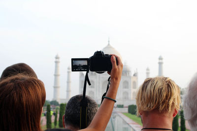 Rear view of woman photographing