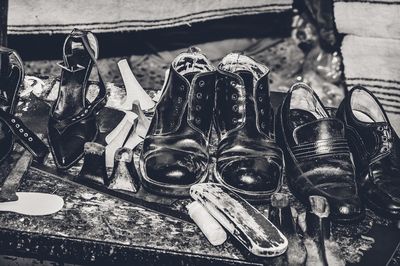 High angle view of shoes with tools on table at workshop