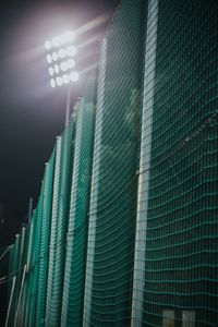 Low angle view of illuminated lighting equipment in building