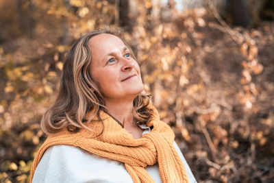 Portrait of smiling young woman during autumn