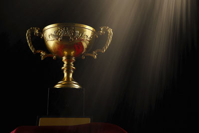 Low angle view of trophy against black background