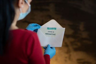 Rear view of woman holding text