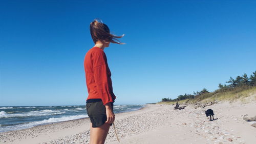 Side view of woman on sandy beach