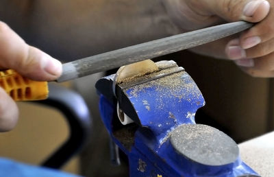 Cropped hands of manual worker working at workshop