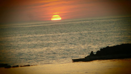 Scenic view of sea against sky at sunset