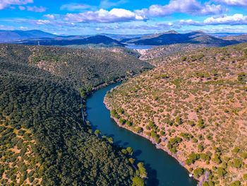 Aerial view of river amidst landscape against sky