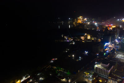 High angle view of illuminated buildings in city at night