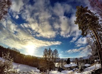 Scenic view of snow covered landscape against cloudy sky