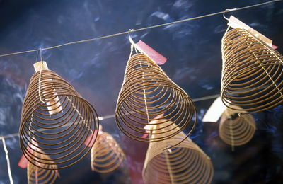 Low angle view of spiral incense sticks in temple