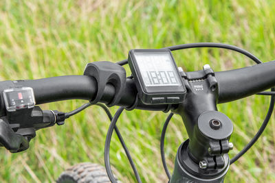 Mountain bike handlebar with 3-speed shifter and wireless bike computer. close-up