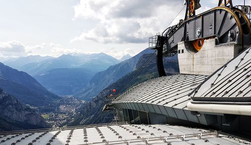 Scenic view of building and mountains against sky