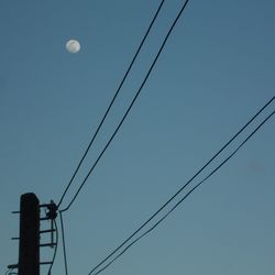 Low angle view of cables against blue sky