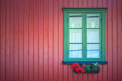 Red flower pot on window of building