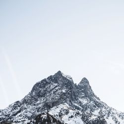 Low angle view of snowcapped mountain against sky