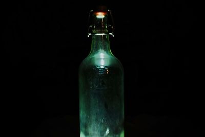 Close-up of beer bottle against black background