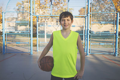 Boy playing basketball on court